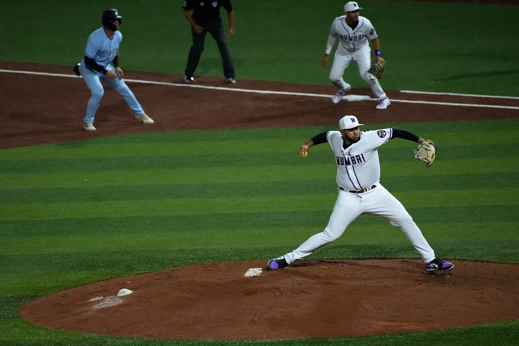 A Mumbai pitcher throws during the league's opening baseball game at the new Barry Larkin Field in Ud al-Bayda, on the outskirts of Dubai, United Arab Emirates, Friday, Nov. 14, 2025. (AP Photo/Fatima Shbair)