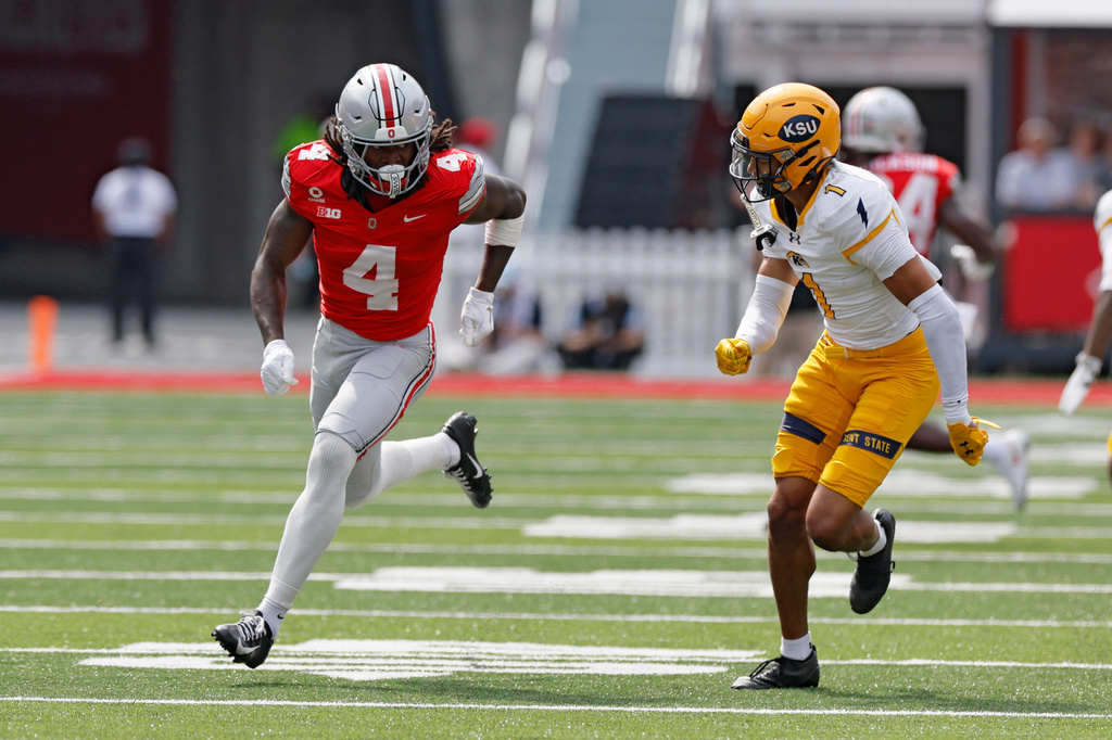 Ohio State wide receiver Jeremiah Smith, left, tries to get open against Kent State defensive back A'tiq Muhammad during the first half of an NCAA college football game, Saturday, Sept. 19, 2026, in Columbus, Ohio. (AP Photo/Jay LaPrete)
