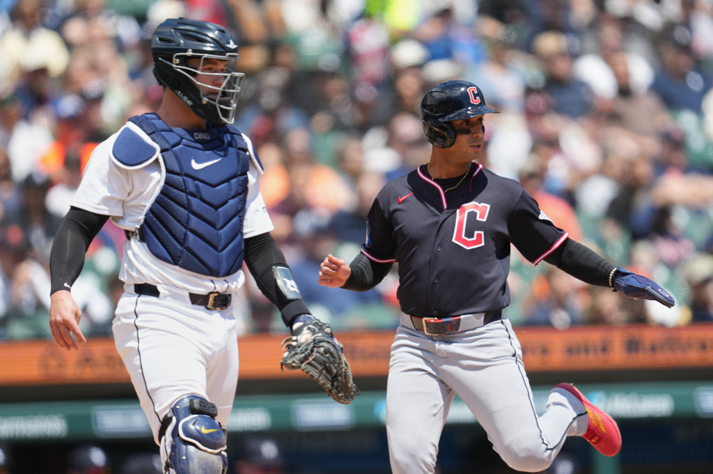 Cleveland Guardians' Brayan Rocchio, right, scores as Detroit Tigers catcher Dillon Dingler, left, looks on during the third inning of a baseball game Thursday, May 21, 2026, in Detroit. (AP Photo/Paul Sancya)
