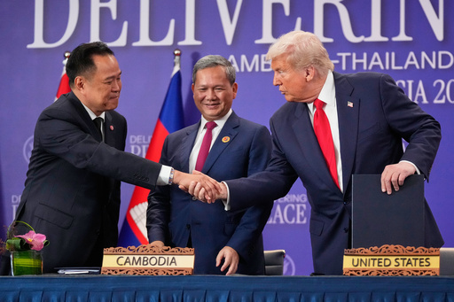 President Donald Trump shakes hands with Thailand's Prime Minister Anutin Charnvirakul, left, as Cambodian Prime Minister Hun Manet watches during a signing ceremony on the sidelines of the ASEAN Summit in Kuala Lumpur, Malaysia, Sunday, Oct. 26, 2025. (AP Photo/Mark Schiefelbein) President Donald Trump shakes hands with Thailand's Prime Minister Anutin Charnvirakul, left, as Cambodian Prime Minister Hun Manet watches during a signing ceremony on the sidelines of the ASEAN Summit in Kuala Lumpur, Malaysia, Sunday, Oct. 26, 2025. (AP Photo/Mark Schiefelbein)
