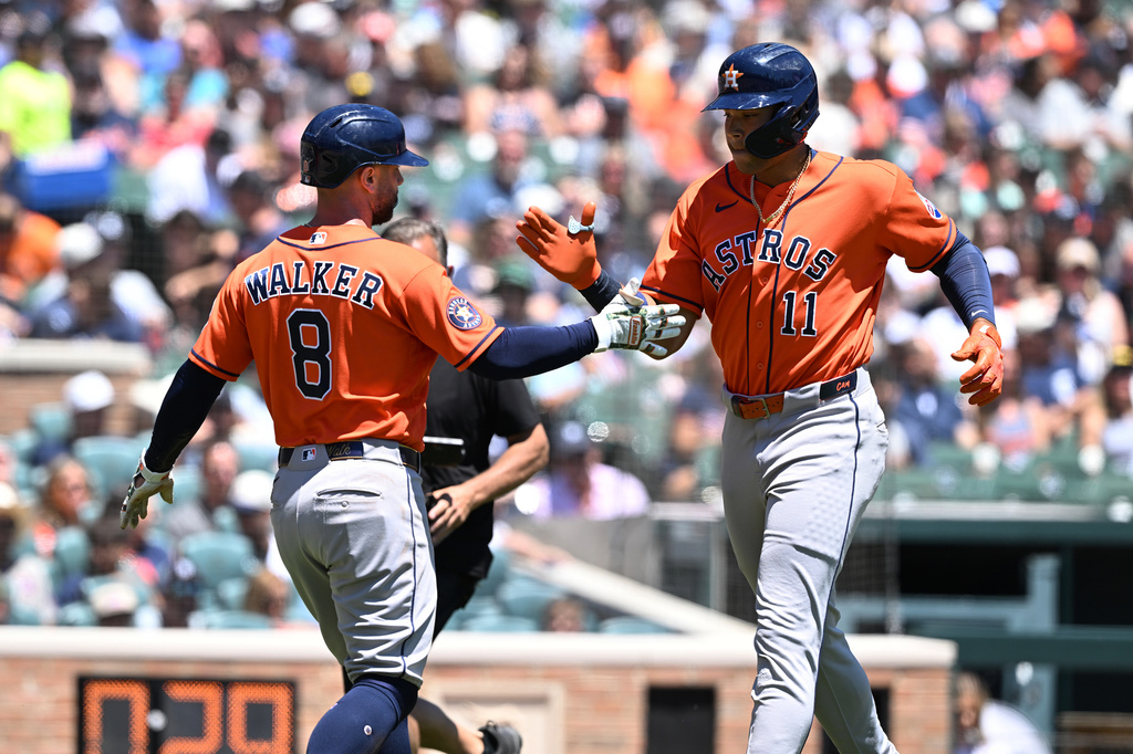 Houston Astros' Christian Walker (8) greets Cam Smith (11) at home plate after Smith hit a two-run home run against the Detroit Tigers in the second inning of a baseball game, Saturday, June 27, 2026, in Detroit. (AP Photo/Lon Horwedel)