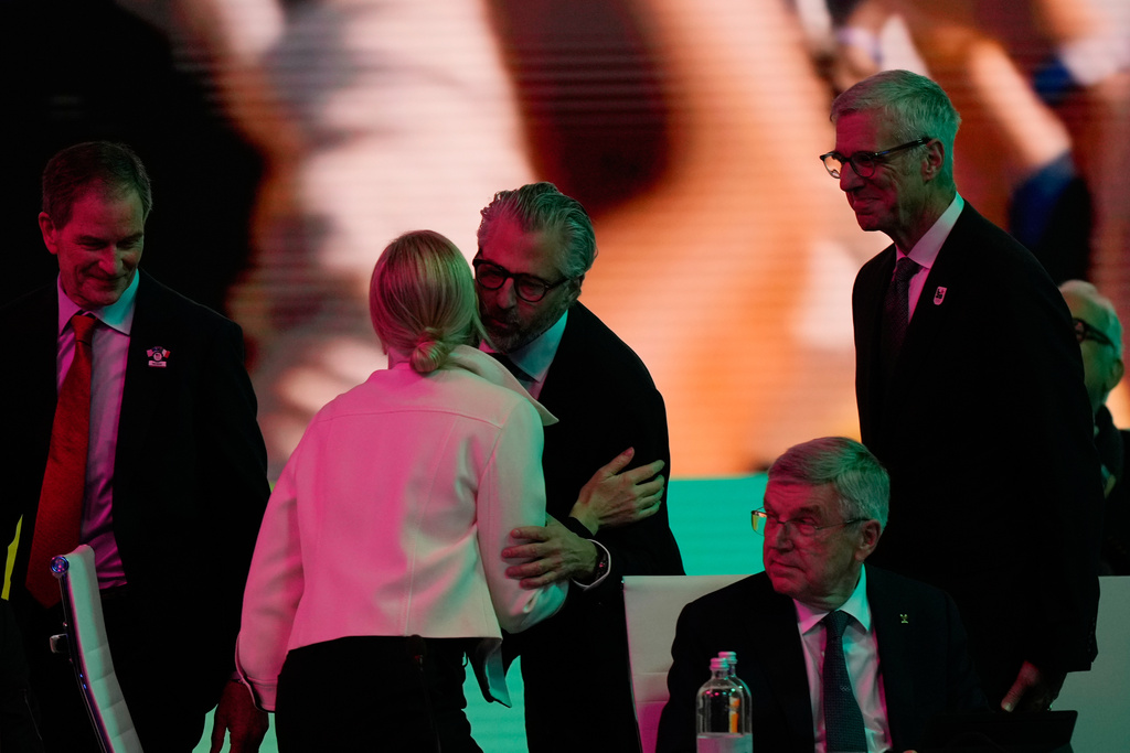 Casey Wasserman, Chairman of the Los Angeles Organizing Committee for the 2028 Olympic and Paralympic Games greets IOC President Kirsty Coventry during an IOC meeting ahead of the 2026 Winter Olympics, in Milan, Italy, Tuesday, Feb. 3, 2026. (AP Photo/Luca Bruno)