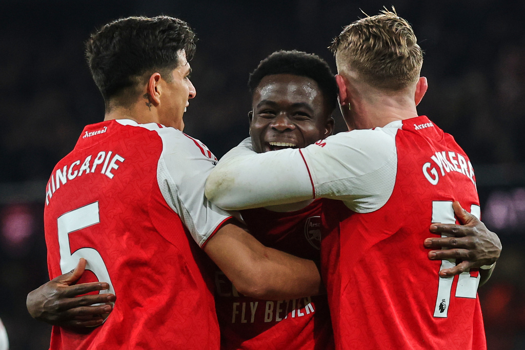 Arsenal's Bukayo Saka, center, celebrates with teammates after his team scored the opening goal during the English Premier League soccer match between Arsenal and Wolves in London, Sunday, Dec. 14, 2025. (AP Photo/Richard Pelham)