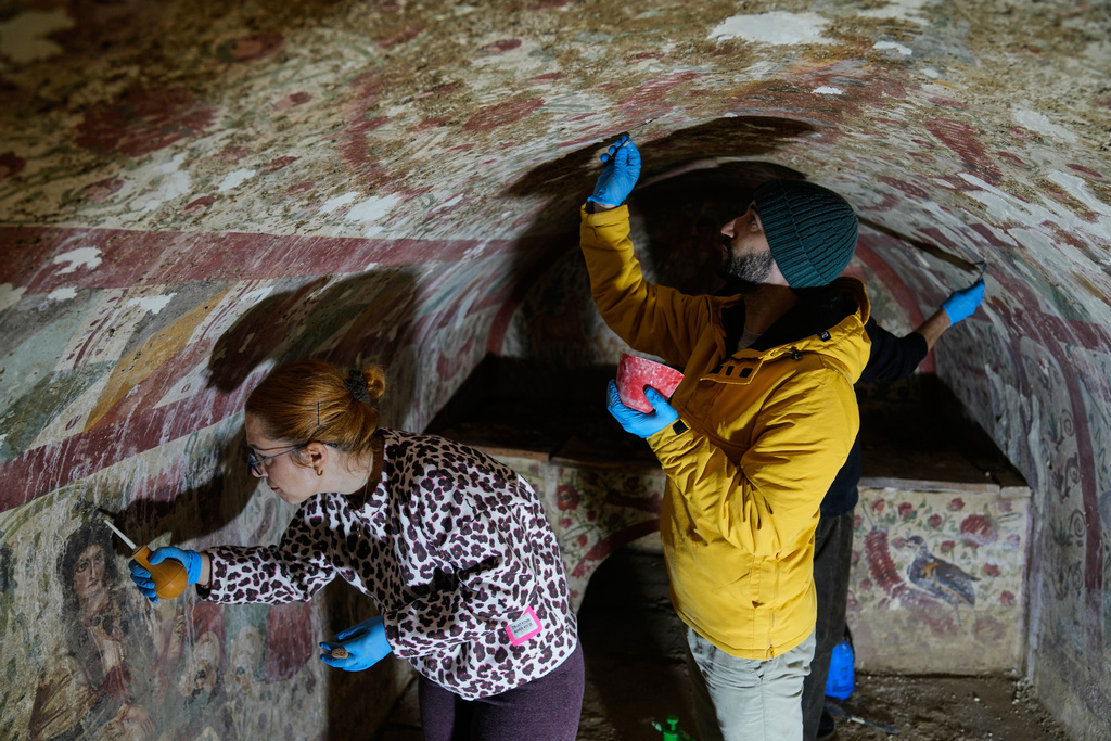 Archaeologists clean and restore frescoes inside a 3rd-century tomb where a rare early Christian depiction of Jesus as the "Good Shepherd" was discovered, in Iznik, Turkey, Friday, Dec. 12, 2025. (AP Photo/Khalil Hamra)
