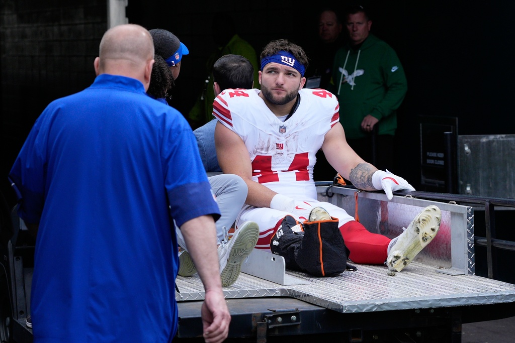 New York Giants running back Cam Skattebo (44) leaves the field after an injury during the first half of an NFL football game against the Philadelphia Eagles on Sunday, Oct. 26, 2025, in Philadelphia. (AP Photo/Chris Szagola)