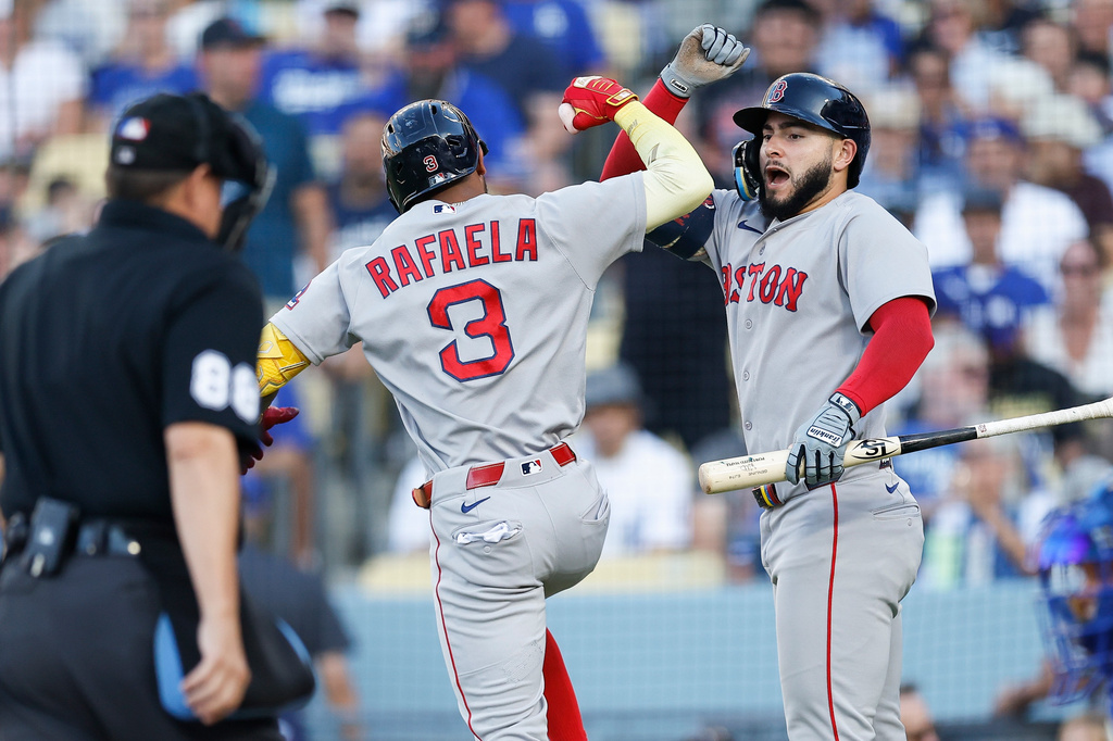 Boston Red Sox's Ceddanne Rafaela (3), left, is greeted by Boston Red Sox's Wilyer Abreu (52) after hitting a solo home run during the first inning of a baseball game against the Los Angeles Dodgers, Saturday, Aug. 1, 2026, in Los Angeles. (AP Photo/Caroline Brehman)
