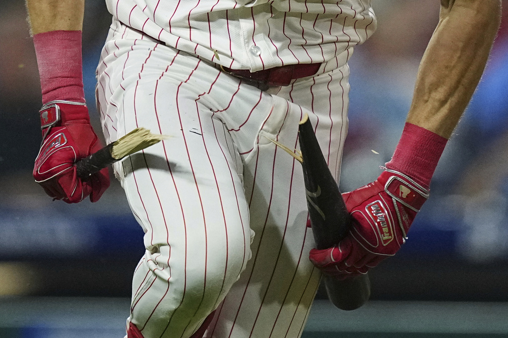 Philadelphia Phillies' Max Kepler breaks his bat over his knee after hitting an RBI single off of New York Mets pitcher Clay Holmes during the fifth inning of a baseball game, Wednesday, Sept. 10, 2025, in Philadelphia. (AP Photo/Matt Rourke)
