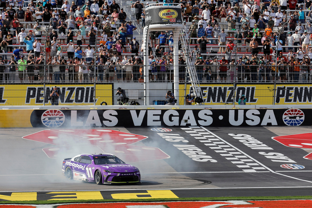 Denny Hamlin (11) performs a burnout after winning a NASCAR Cup Series auto race at Las Vegas Motor Speedway, Sunday, March 15, 2026, in Las Vegas. (AP Photo/Steve Marcus)