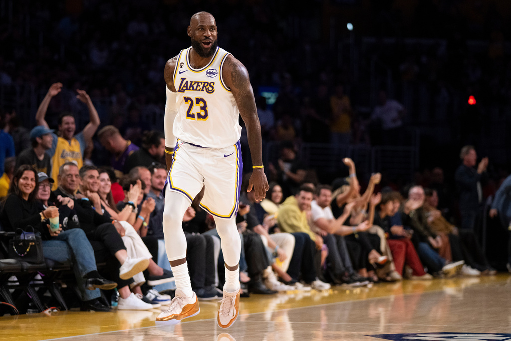 Los Angeles Lakers forward LeBron James reacts after scoring a basket during the first half of an NBA basketball game against the Sacramento Kings in Los Angeles, Sunday, March 1, 2026. (AP Photo/Kyusung Gong)