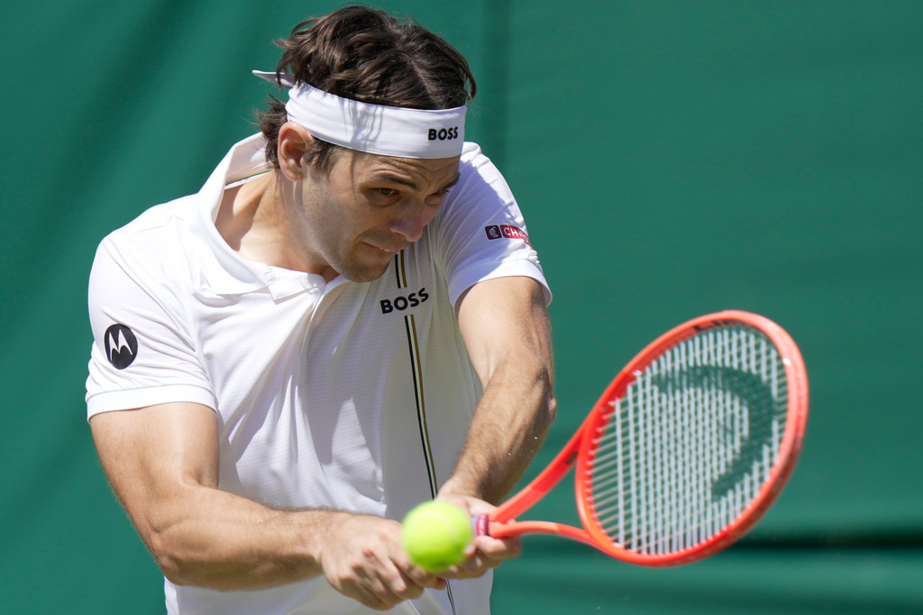 Taylor Fritz of the United States returns the ball to Patrick Kypson of the United States in their second round men's singles match at the Wimbledon Tennis Championships in London, Thursday, July 2, 2026. (AP Photo/Brian Inganga)
