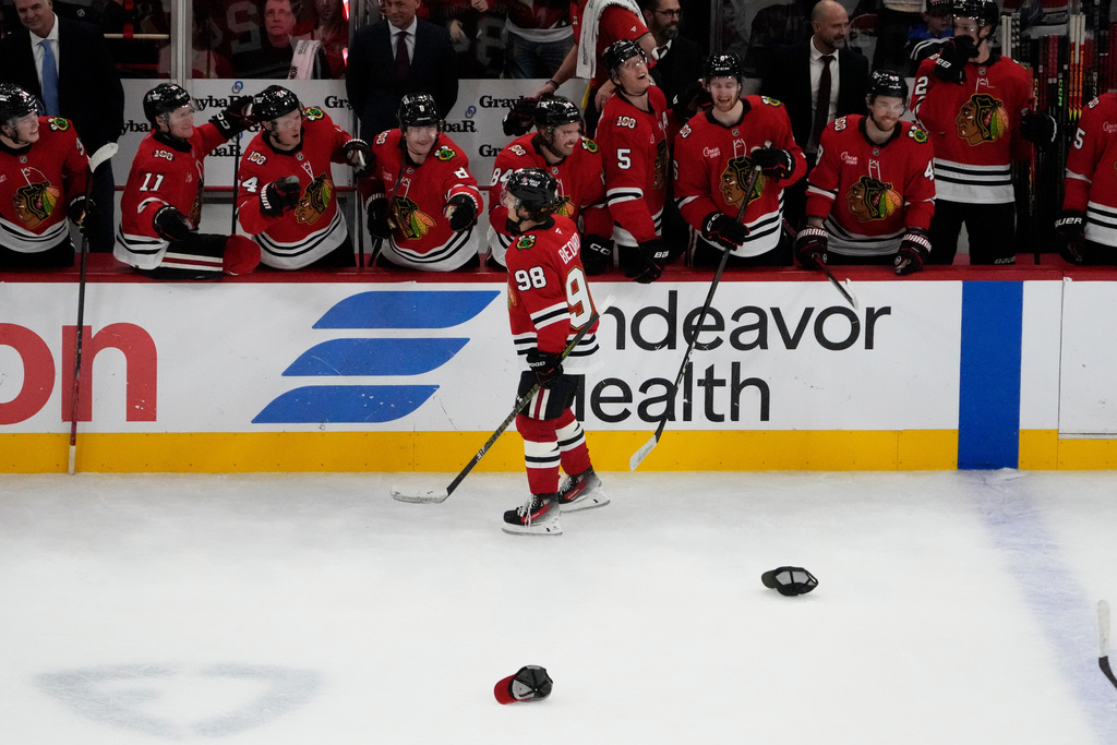 Chicago Blackhawks center Connor Bedard (98) celebrates his hat trick against the Calgary Flames during the third period of an NHL hockey game, Tuesday, Nov. 18, 2025, in Chicago. (AP Photo/David Banks)