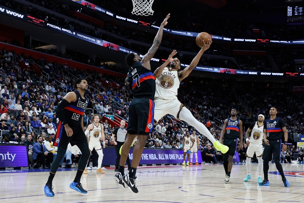 Golden State Warriors guard De'anthony Melton (8) goes up to shoot against Detroit Pistons forward Paul Reed (7) during the first half of an NBA basketball game Friday, March 20, 2026, in Detroit. (AP Photo/Duane Burleson)