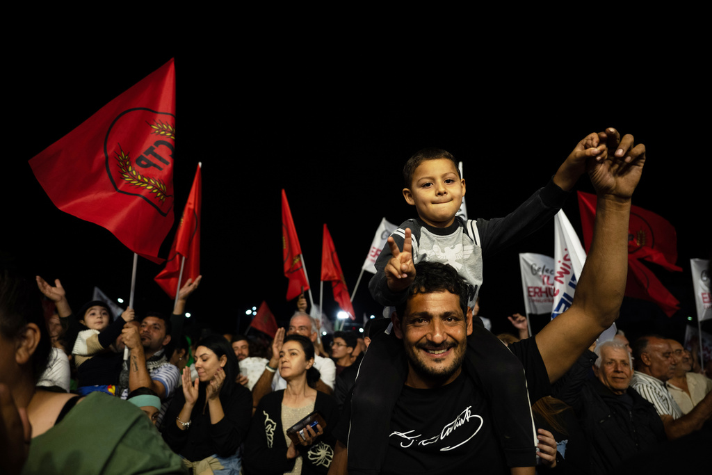 Supporters of the newly elected leader Tufan Erhurman celebrate after winning the leadership election in the Turkish occupied northern part of the divided capital Nicosia, Cyprus, Sunday, Oct. 19, 2025. (AP Photo/Nedim Enginsoy)