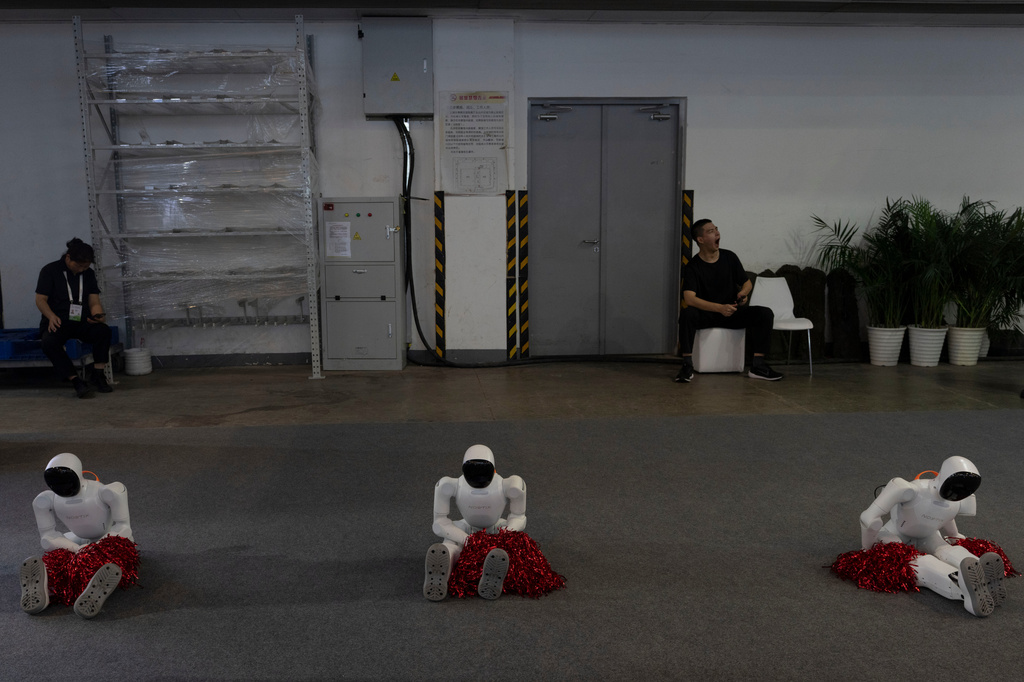 Robots with pomp pomps wait to be activated during the World AI Conference in Shanghai, Saturday, July 18, 2026. (AP Photo/Ng Han Guan)