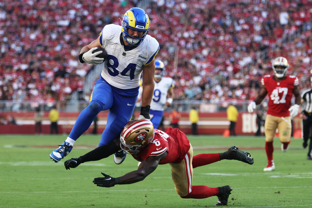 Los Angeles Rams tight end Colby Parkinson (84) is tackled by San Francisco 49ers safety Malik Mustapha (6) during the second half of an NFL football game in Santa Clara, Calif., Sunday, Nov. 9, 2025. (AP Photo/Jed Jacobsohn)