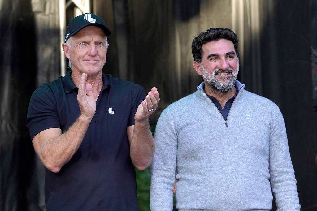 FILE - LIV Golf CEO Greg Norman, left, applauds Yasir Al-Rumayyan, Governor of Public Investment Fund of Saudi Arabia, at the LIV Golf Invitational-Chicago tournament Sept. 18, 2022, in Sugar Hill, Ill. (AP Photo/Charles Rex Arbogast, File)