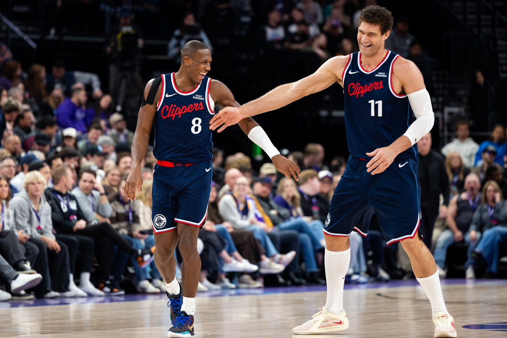 Los Angeles Clippers guard Kris Dunn (8) and center Brook Lopez (11) celebrate a play during the second half of an NBA basketball game against the Utah Jazz, Tuesday, Jan. 27, 2026, in Salt Lake City. (AP Photo/Anna Fuder)