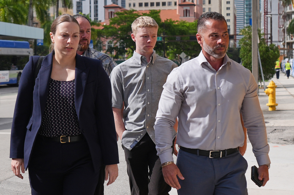 Timothy Hudson, center, charged with sexually assaulting and killing his 18-year-old stepsister on a Carnival Cruise ship, arrives for a hearing at the The James Lawrence King Federal Justice Building, Wednesday, May 27, 2026, in Miami. (AP Photo/Rebecca Blackwell)