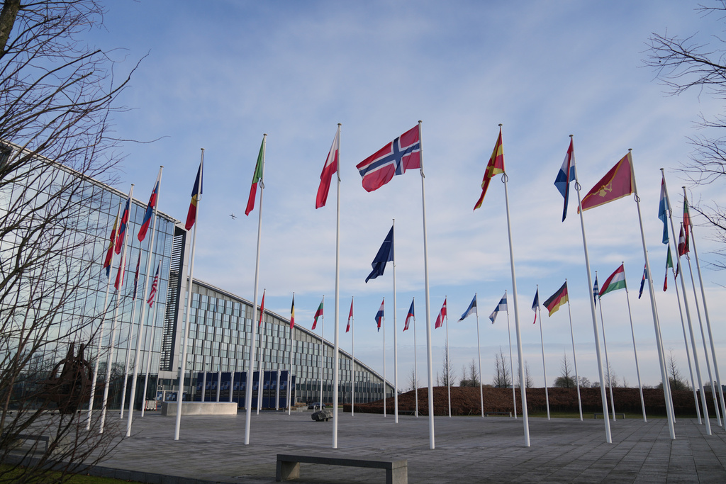 Flags flap in the wind outside NATO headquarters in Brussels, Monday, Jan. 19, 2026. (AP Photo/Virginia Mayo)