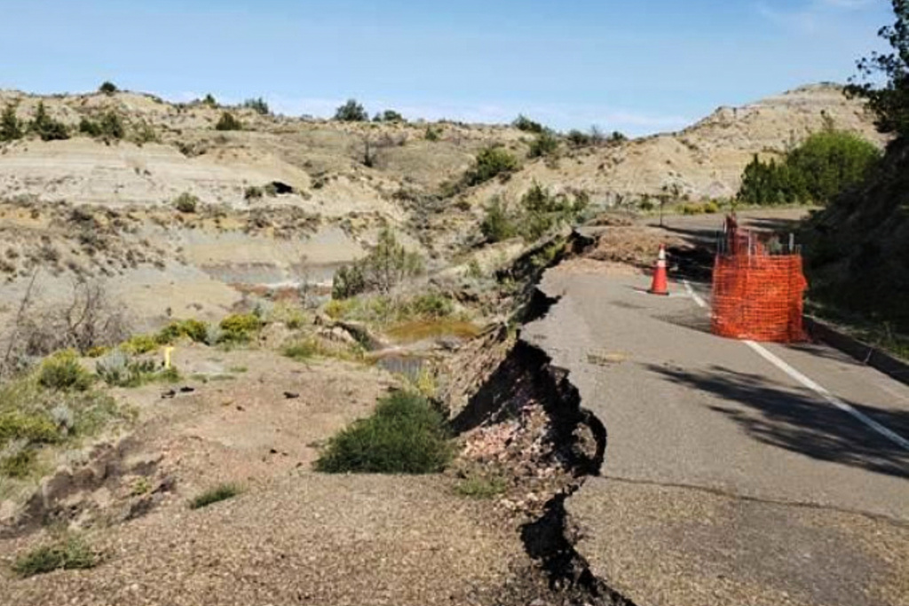 This image provided by the National Park Service shows the collapsed road along Theodore Roosevelt National Park’s scenic loop drive before reconstruction began in North Dakota. (National Park Service via AP)