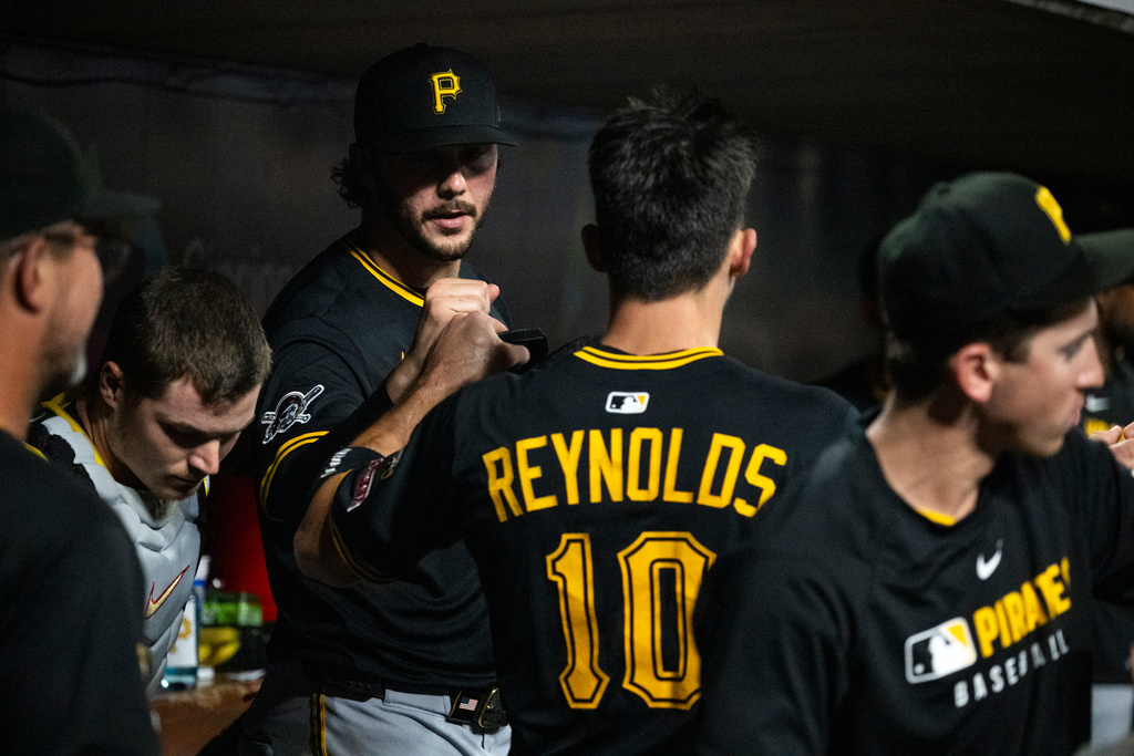 Pittsburgh Pirates' Bryan Reynolds and Paul Skenes celebrate Reynolds' scored run in the sixth inning of a baseball game against the Cincinnati Reds, Wednesday, Sept. 24, 2025, in Cincinnati. (AP Photo/Michael Swensen)