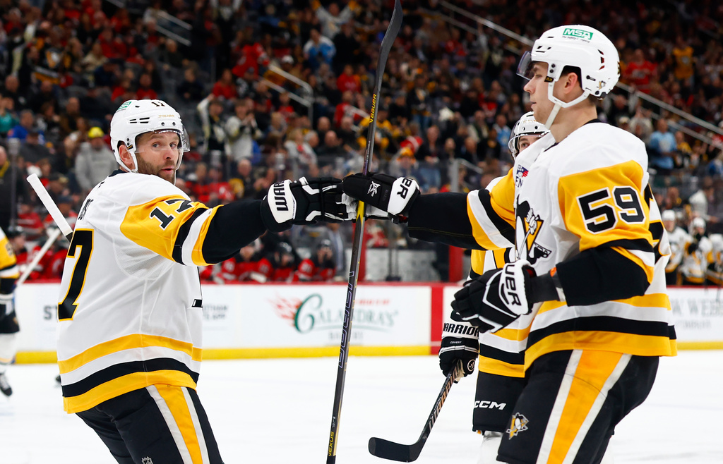 Pittsburgh Penguins right wings Bryan Rust (17) celebrates with Egor Chinakhov (59) after scoring a goal against the New Jersey Devils during the first period of an NHL hockey game, Thursday, April 9, 2026, in Newark, N.J. (AP Photo/Noah K. Murray)