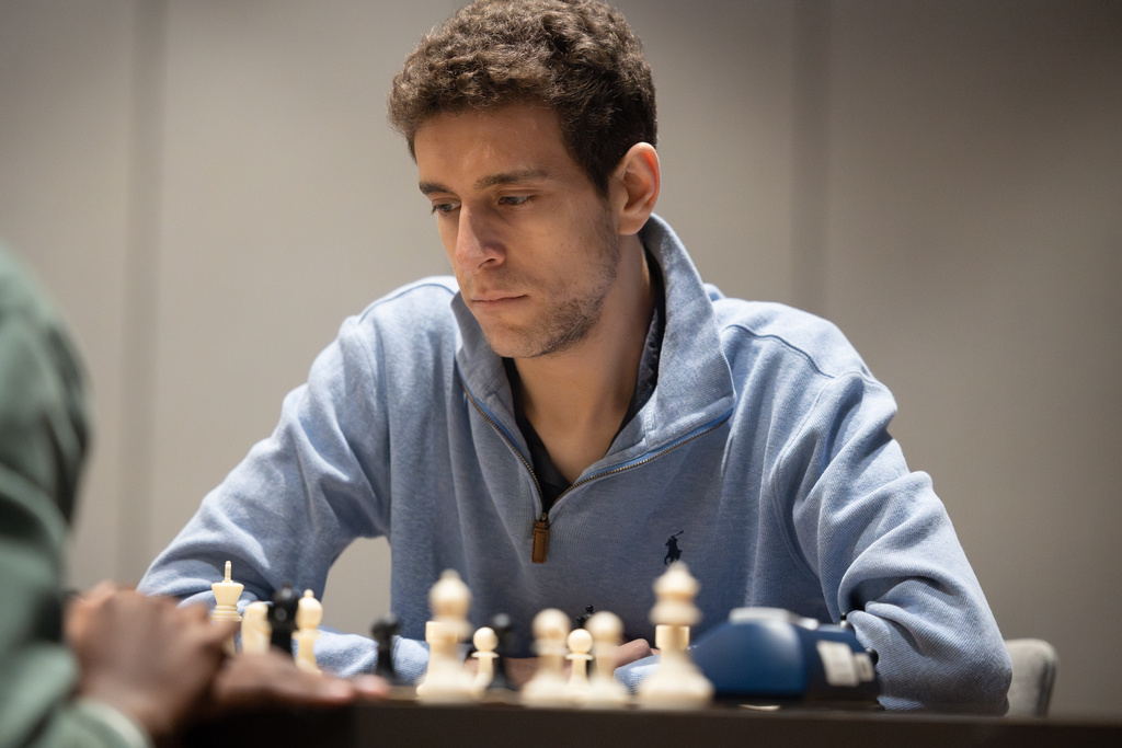 This undated photo released by Charlotte Chess Center shows Daniel Naroditsky playing chess on the board. (Kelly Centrelli/Charlotte Chess Center via AP