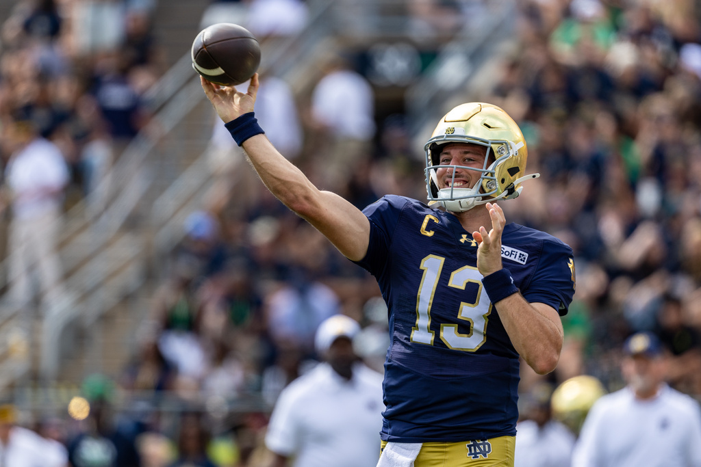 Notre Dame quarterback CJ Carr (13) throws before an NCAA college football game against Rice, Saturday, Sept. 12, 2026, in South Bend, Ind. (AP Photo/Paul Barnick)