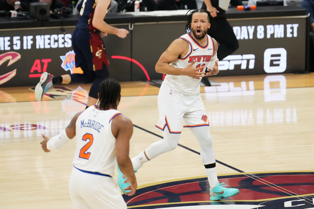 New York Knicks guard Jalen Brunson (11) celebrates with guard Miles McBride (2) during the second half of Game 4 in the Eastern Conference finals NBA basketball playoffs series against the Cleveland Cavaliers in Cleveland, Monday, May 25, 2026. (AP Photo/Sue Ogrocki)