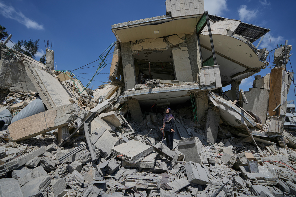 Hanan Qubaisi inspects her house destroyed in previous Israeli airstrikes in the town of Nabatiyeh, southern Lebanon, Wednesday, June 24, 2026, after a ceasefire between Israel and Hezbollah. (AP Photo/Bilal Hussein)