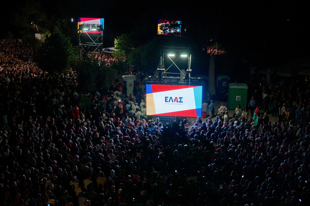 The logo of ELAS, the new party founded by former left-wing Prime Minister Alexis Tsipras, is displayed on giant screens ahead of next year's elections in Athens on Tuesday, May 26, 2026. (AP Photo/Petros Giannakouris)