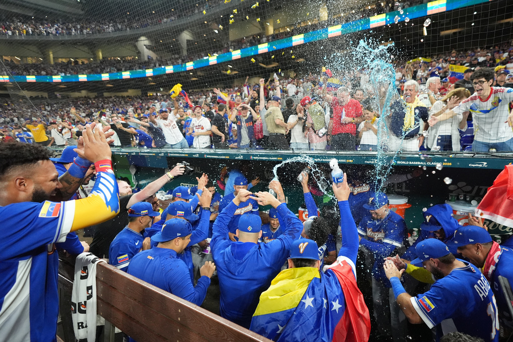 The Venezuela team celebrates after defeating Italy at a World Baseball Classic semifinal game, Monday, March 16, 2026, in Miami. (AP Photo/Rebecca Blackwell)