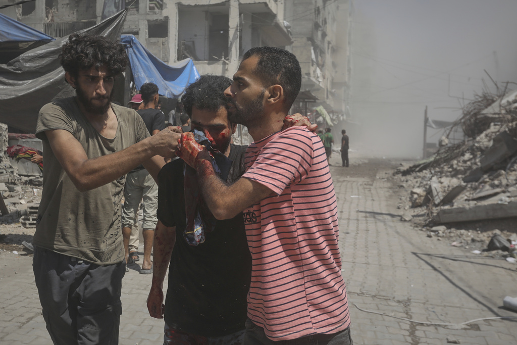 Palestinians evacuate a man who was injured in an Israeli military strike on a building in Gaza City, Saturday, Sept. 13, 2025. (AP Photo/Yousef Al Zanoun)