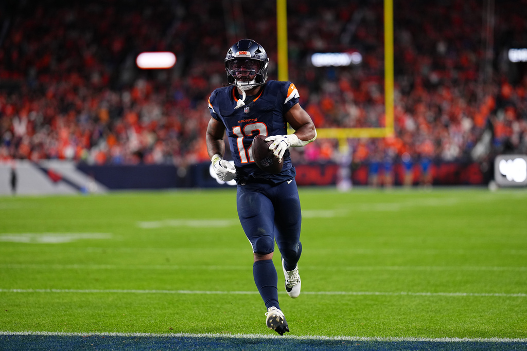 Denver Broncos running back RJ Harvey (12) scores a touchdown against the Cincinnati Bengals during the second half of an NFL football game Monday, Sept. 29, 2025, in Denver. (AP Photo/Jack Dempsey)