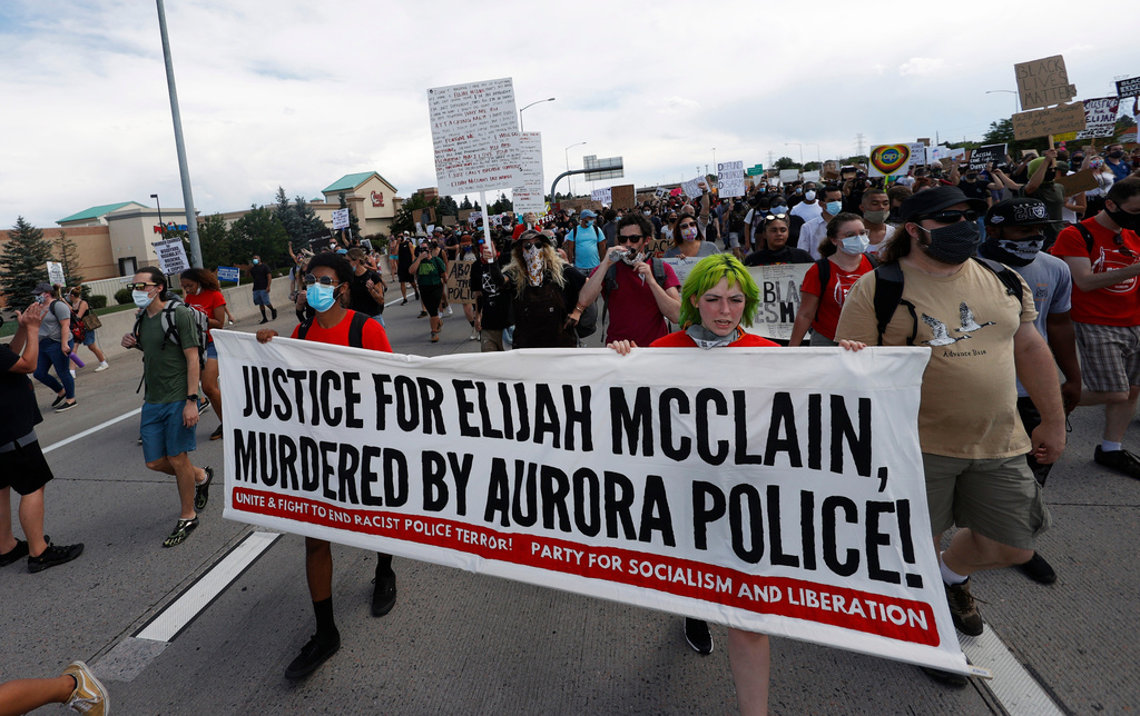FILE - Demonstrators carry a banner while marching down Interstate 225 during a rally and march over the death of Elijah McClain, June 27, 2020, in Aurora, Colo. A trial for two of the officers charged for McClain's death is set to begin Friday, Sept. 15, 2023 with jury selection. (AP Photo/David Zalubowski, file)