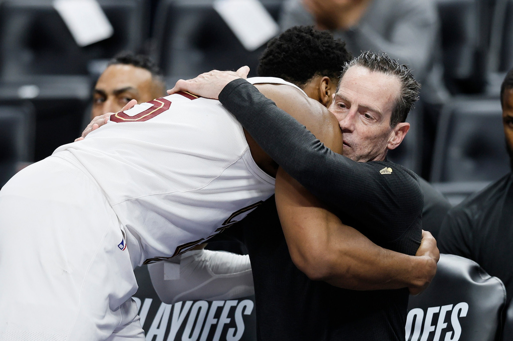 Cleveland Cavaliers guard Donovan Mitchell hugs head coach Kenny Atkinson as he leaves the game against the Detroit Pistons during the fourth quarter of Game 7 in a second-round NBA basketball playoffs series, Sunday, May 17, 2026, in Detroit. (AP Photo/Duane Burleson)
