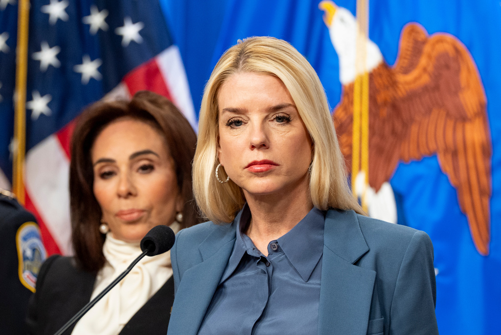 Attorney General Pam Bondi, with U.S. Attorney Jeanine Pirro behind, pauses while speaking during a news conference at the Department of Justice, Thursday, Dec. 4, 2025, in Washington. (AP Photo/Alex Brandon)