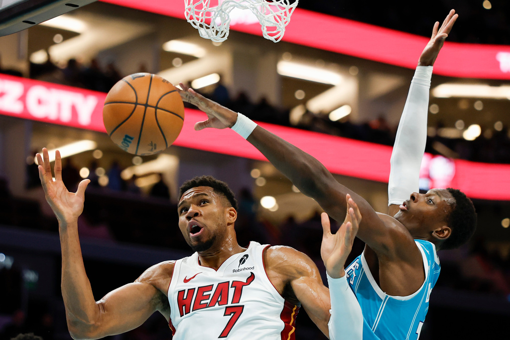 Miami Heat forward Giannis Antetokounmpo (7) battles Charlotte Hornets forward Moussa Diabate for a rebound during the second half of an NBA basketball game in Charlotte, N.C., Saturday, Oct. 24, 2026. (AP Photo/Nell Redmond)