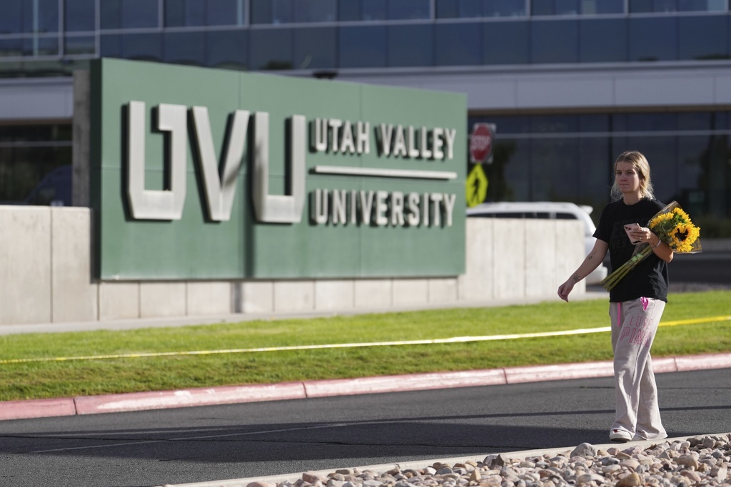 Meagan Bradley walks to a memorial for Charlie Kirk at Utah Valley University in Orem, Utah, Friday, Sept. 12, 2025. (AP Photo/Lindsey Wasson)