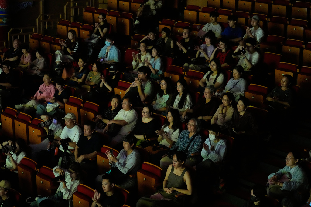Audience members watch and applaud during a Peking Opera show at Jixiang Theatre in Beijing, China, Sunday, Sept. 7, 2025. (AP Photo/Mahesh Kumar A.)