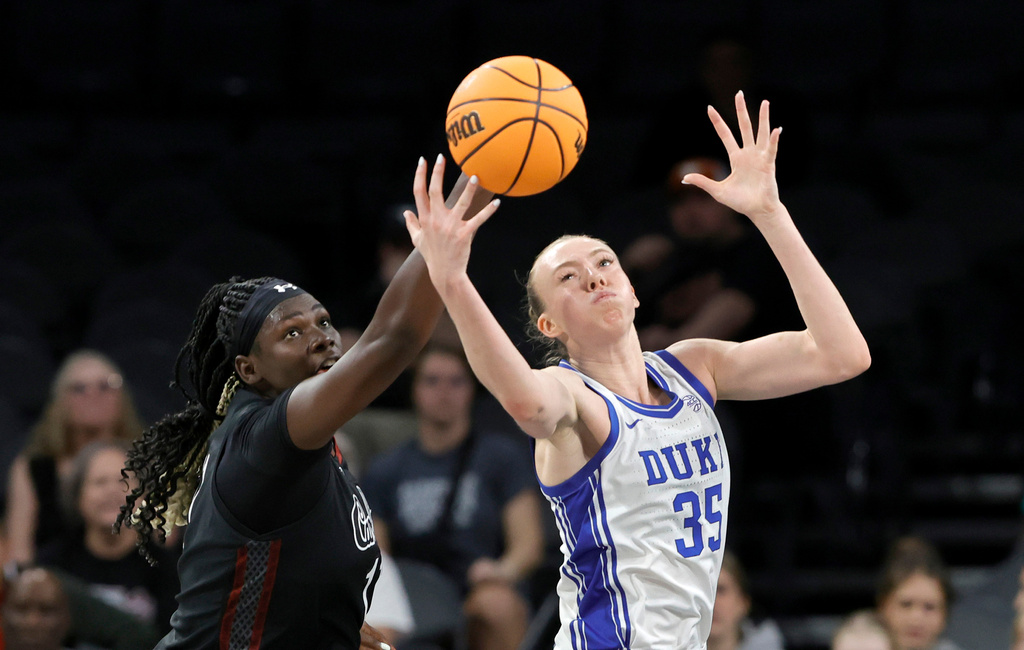 South Carolina center Madina Okot, left, and Duke forward Toby Fournier (35) fight for a rebound during the first half of an NCAA college basketball game in the Players Era tournament Wednesday, Nov. 26, 2025, in Las Vegas. (AP Photo/Steve Marcus)