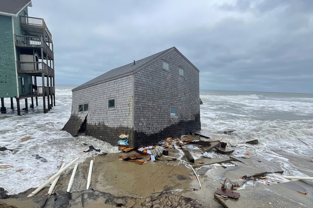A collapsed beach cottage sits in waves on the shore Tuesday, Sept. 16, 2025, Buxton, NC. (Cape Hatteras National Seashore via AP)