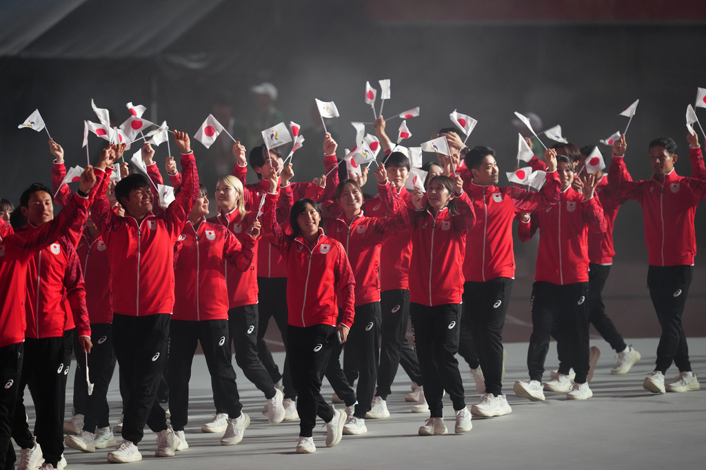 Members of Japan's contingent walk during the opening ceremony for the Asian Games in Nagoya, Japan, Saturday, Sept. 19, 2026. (AP Photo/Aaron Favila)