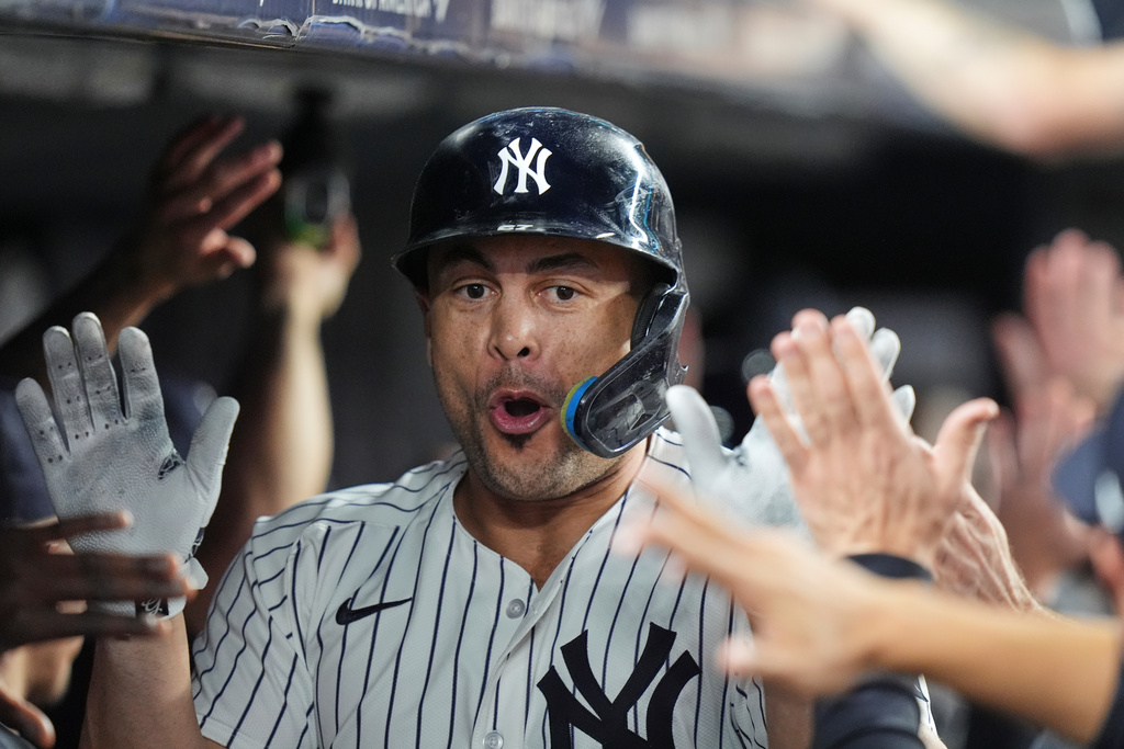 New York Yankees' Giancarlo Stanton celebrates with teammates after hitting a two-run home run during the third inning of a baseball game against the Baltimore Orioles Friday, Sept. 26, 2025, in New York. (AP Photo/Frank Franklin II)