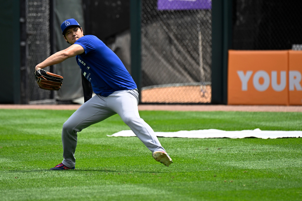 Los Angeles Dodgers two-way player Shohei Ohtani, from Japan, warms up before a baseball game against the Chicago White Sox, Saturday, June 13, 2026, in Chicago. (AP Photo/Matt Marton)