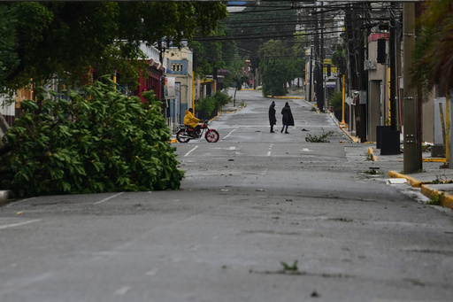 People walk in Kingston, Jamaica, as Hurricane Melissa approaches, Tuesday, Oct. 28, 2025. (AP Photo/Matias Delacroix) People walk in Kingston, Jamaica, as Hurricane Melissa approaches, Tuesday, Oct. 28, 2025. (AP Photo/Matias Delacroix)