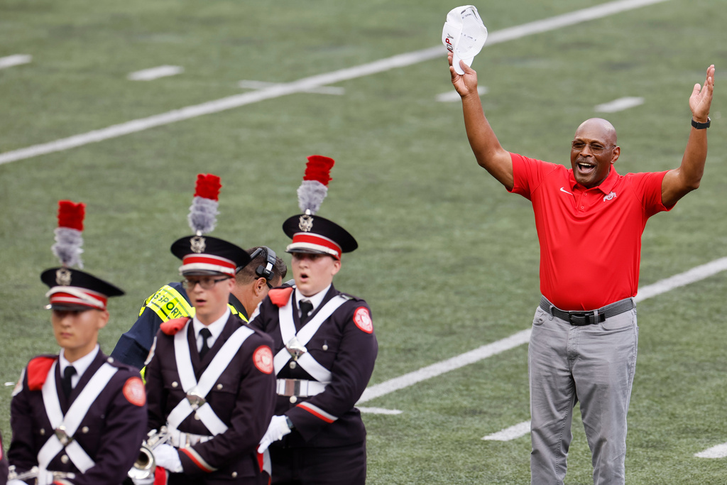 FILE - Archie Griffin, two-time Heisman Trophy winner from Ohio State, dots the I in "Script Ohio" during half time of an NCAA college football game against Akron Saturday, Aug. 31, 2024, in Columbus, Ohio. (AP Photo/Jay LaPrete, File)