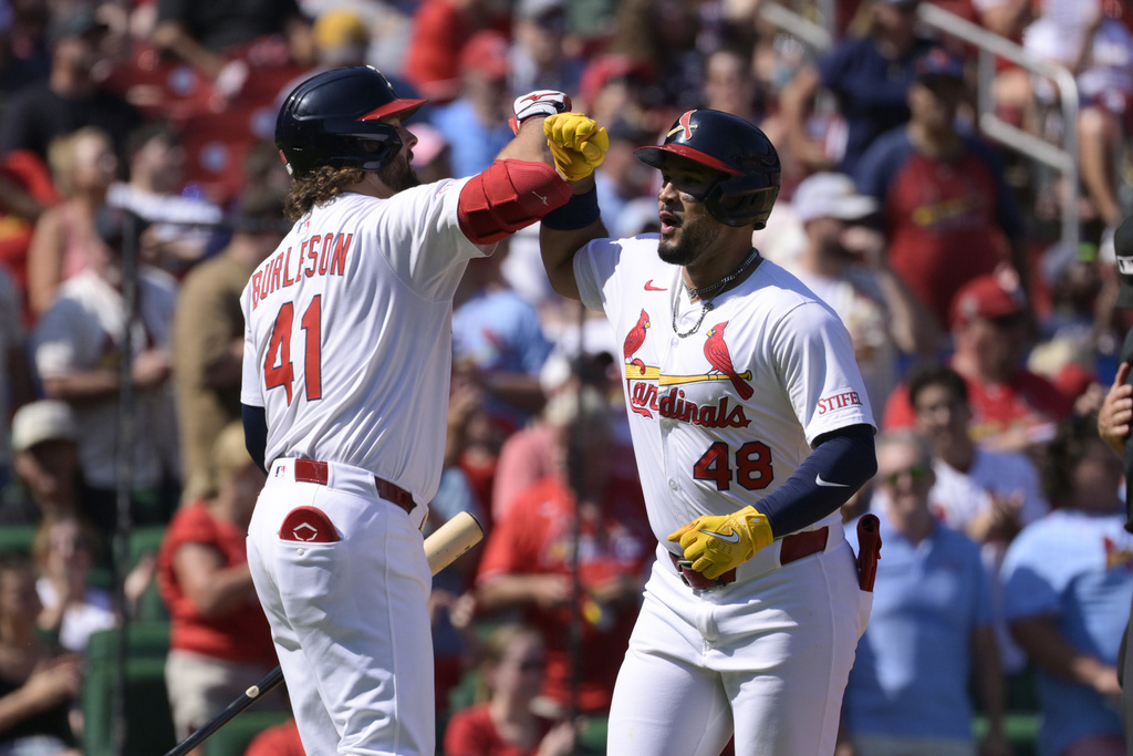 St. Louis Cardinals' Ivan Herrera (48) reacts with Alec Burleson (41) after hitting a two-run home run against the Milwaukee Brewers during the third inning of a baseball game Sunday, Sept. 21, 2025, in St. Louis. (AP Photo/Jeff Le)