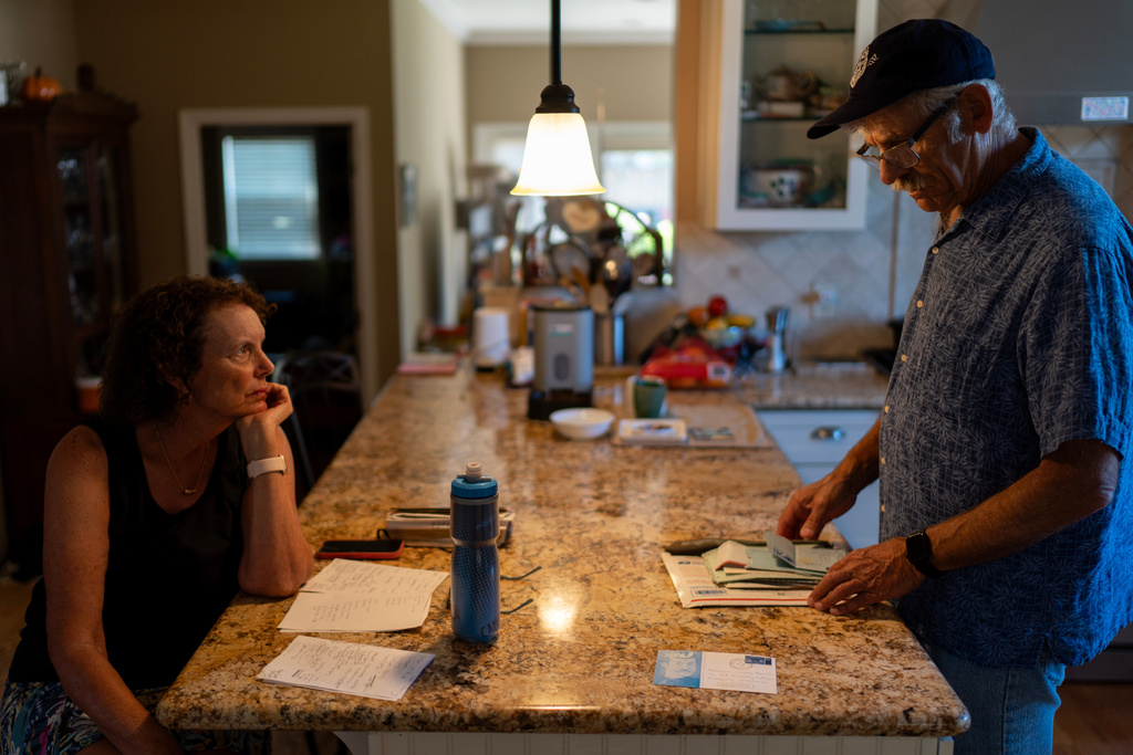Christy Morrill, right, who lost decades of memories to autoimmune encephalitis, talks with his wife, Karen, at their home, Monday, Aug. 18, 2025, in San Carlos, Calif. (AP Photo/David Goldman)