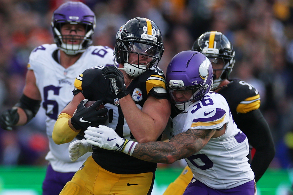 Pittsburgh Steelers outside linebacker TJ. Watt (90) is tackled by Minnesota Vikings running back Zavier Scott (36) during the NFL football game between Minnesota Vikings and Pittsburgh Steelers at Croke Park stadium in Dublin, Sunday, Sept. 28, 2025.(AP Photo/Ian Walton)